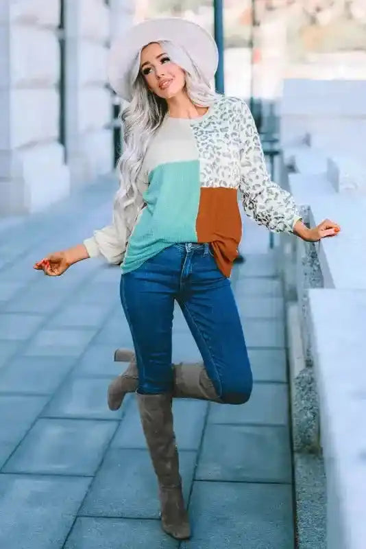 Leopard patchwork color block ribbed long sleeve top styled with skinny jeans and boots, perfect for autumn fashion.