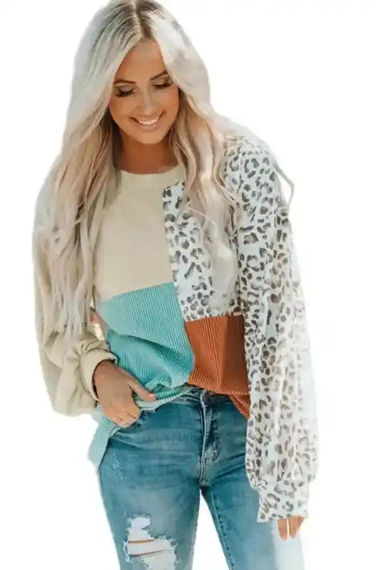Model wearing long sleeve tops leopard patchwork color block ribbed long in beige, teal, rust, and leopard print with distressed jeans.