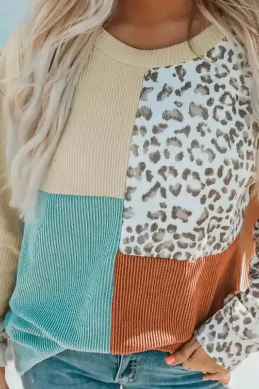 Close-up of leopard patchwork color block ribbed long sleeve top showing detailed knit texture and bold fall colors.