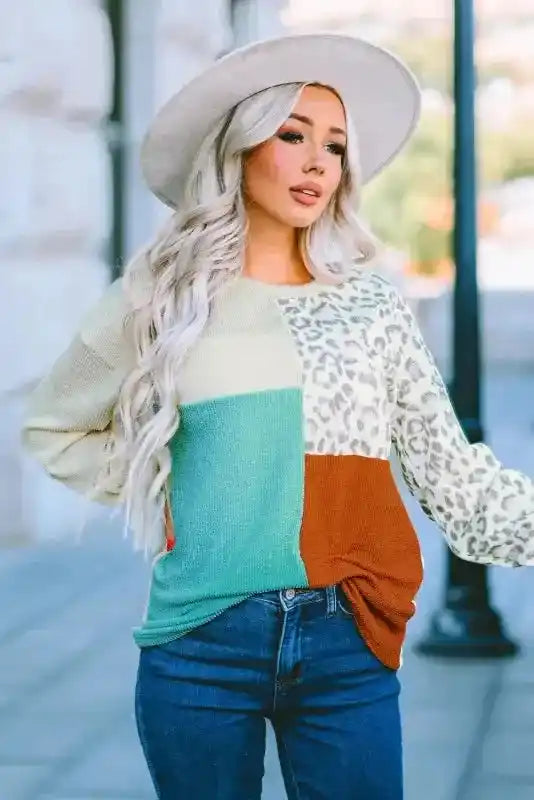Long sleeve ribbed top with leopard print and color block panels, styled with high-waisted jeans and fall accessories.
