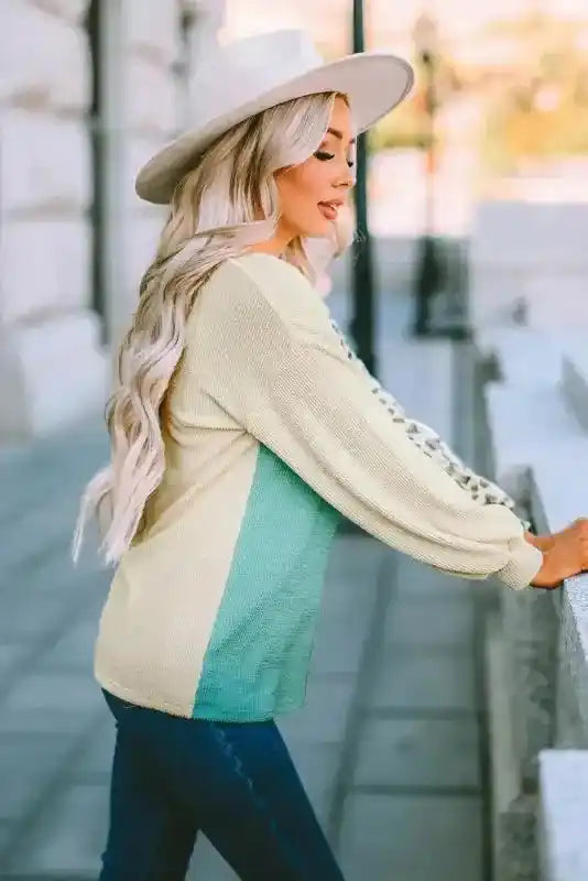Side view of ribbed long sleeve top with color block and leopard print, showing relaxed fit and casual fall styling.