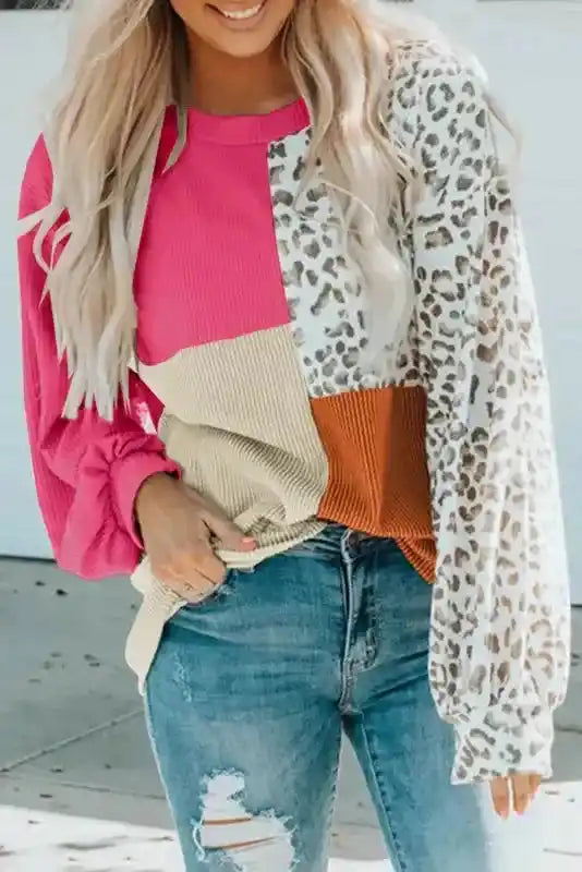 Pink version of leopard patchwork ribbed long sleeve top with beige and rust color blocks, styled with distressed jeans for a trendy look.