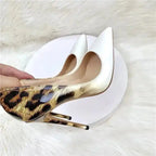 Close-up of gradient leopard print stiletto pumps with white pointed toe. Elegant leather heels for fashion-forward women at FashionFitz.