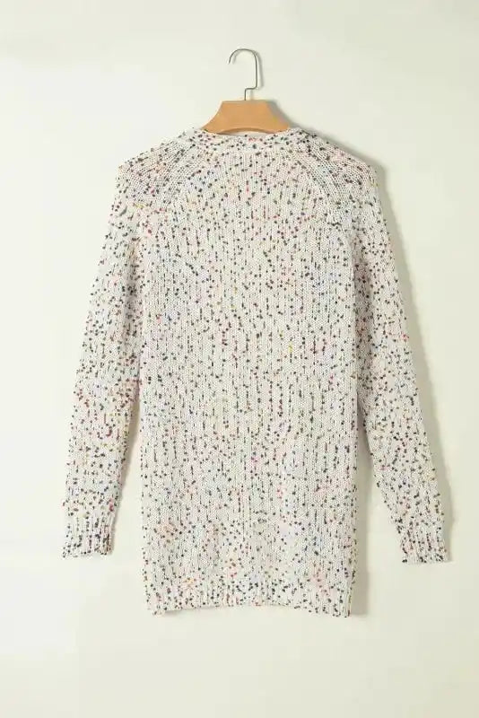 Back view of colorful cable knit sweater with multicolor dots, ideal for cozy winter layering in vibrant style.