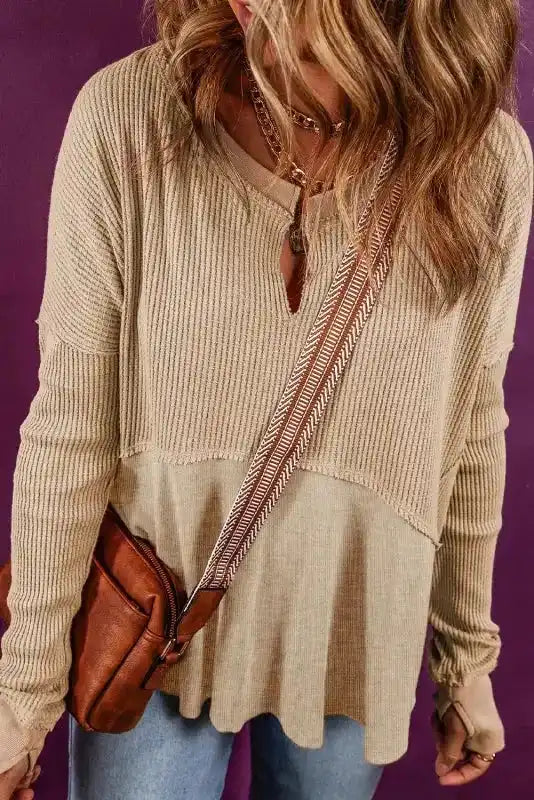 Women's Exposed Seam Waffle Knit Tunic Top in beige styled with jeans and a brown crossbody bag, ideal for everyday casual outfits.