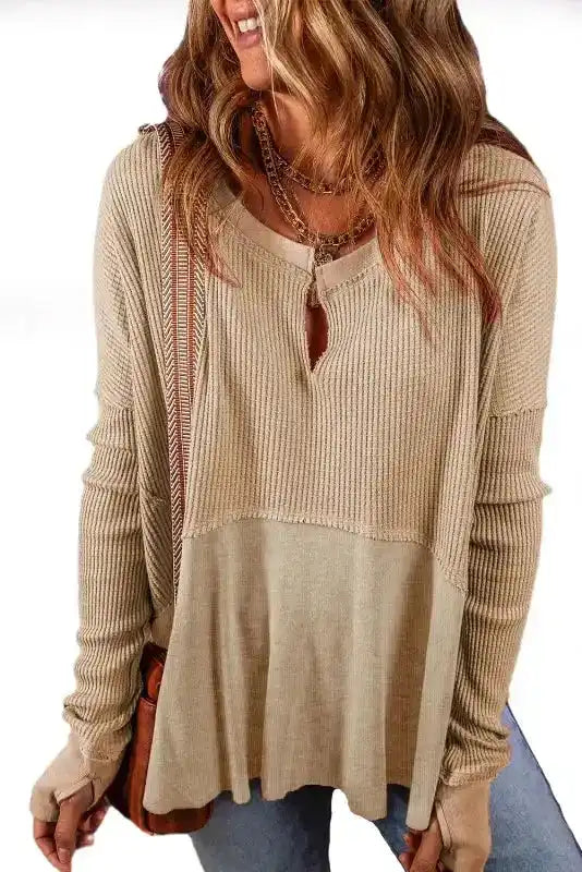 Studio shot of Women's Exposed Seam Waffle Knit Tunic Top in beige, showcasing slit neckline and exposed seam design.