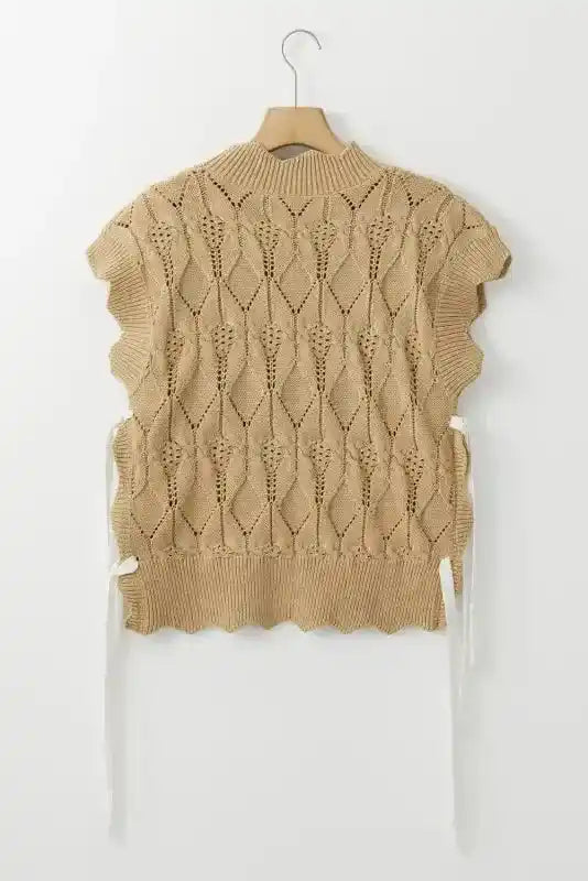 Back flat lay of beige scalloped knit sweater with intricate diamond crochet pattern and high ribbed neckline.