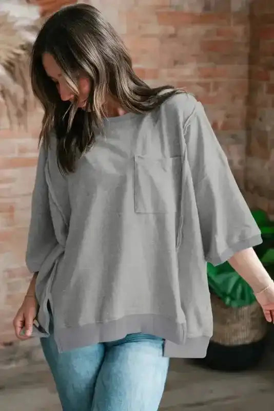 Streetwear look featuring grey exposed-seam t-shirt paired with cargo pants