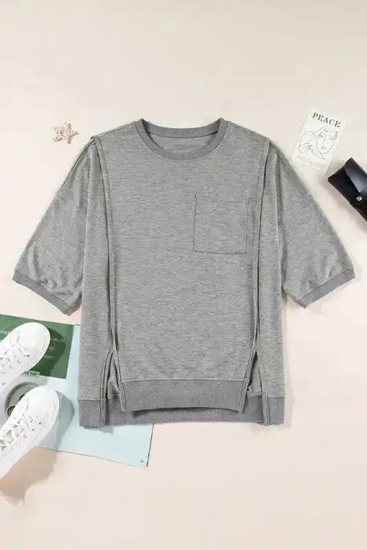 Light grey oversized t-shirt with round neckline and visible seam design laid flat