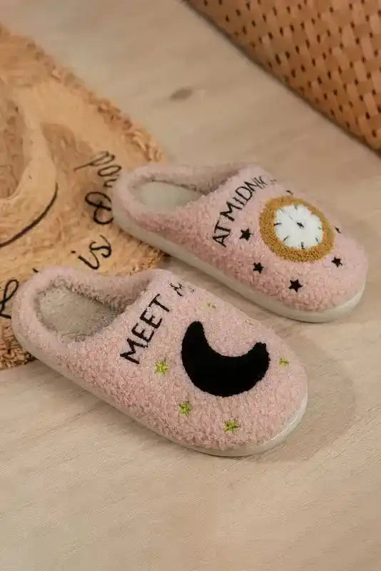 Pair of ladies pink fuzzy home slippers with moon and clock design, ideal for winter comfort and casual indoor lounging.