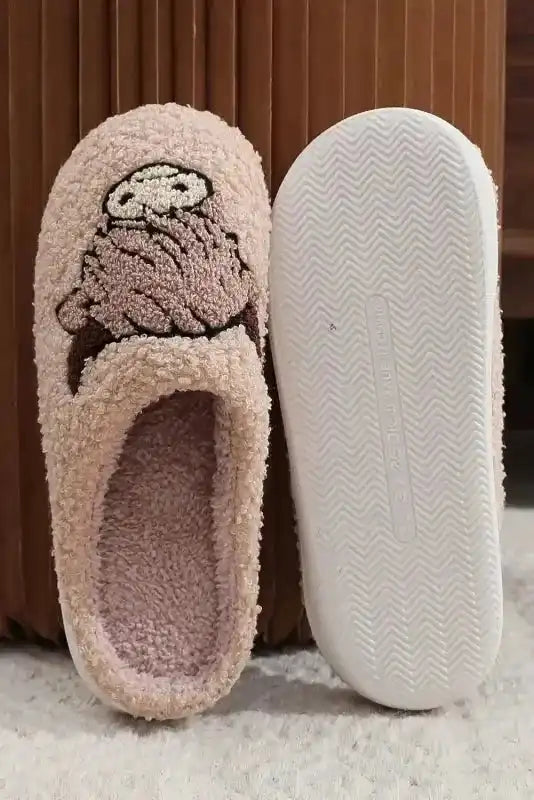 Bottom and top view of pink fuzzy home slippers with embroidered clock design, showcasing anti-slip sole and soft fleece lining.