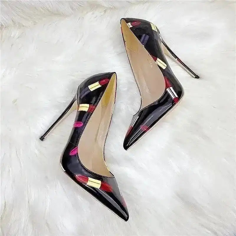 Stylish stiletto pumps with lipstick graffiti design on glossy black PU leather, perfect for fashionistas seeking standout heels.