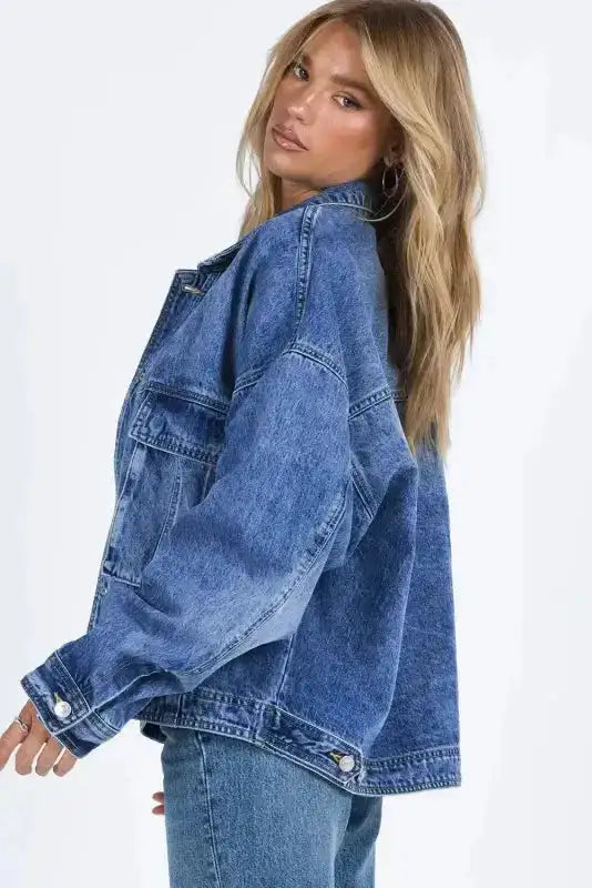 Side view of versatile blue denim jacket for women featuring drop shoulder design and casual solid color finish.