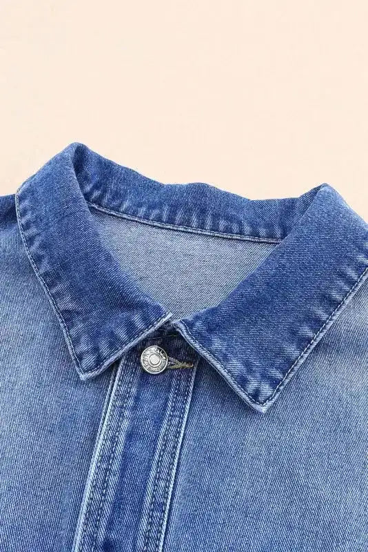 Close-up of collar on women's denim jacket highlighting durable stitching and classic button-down design.