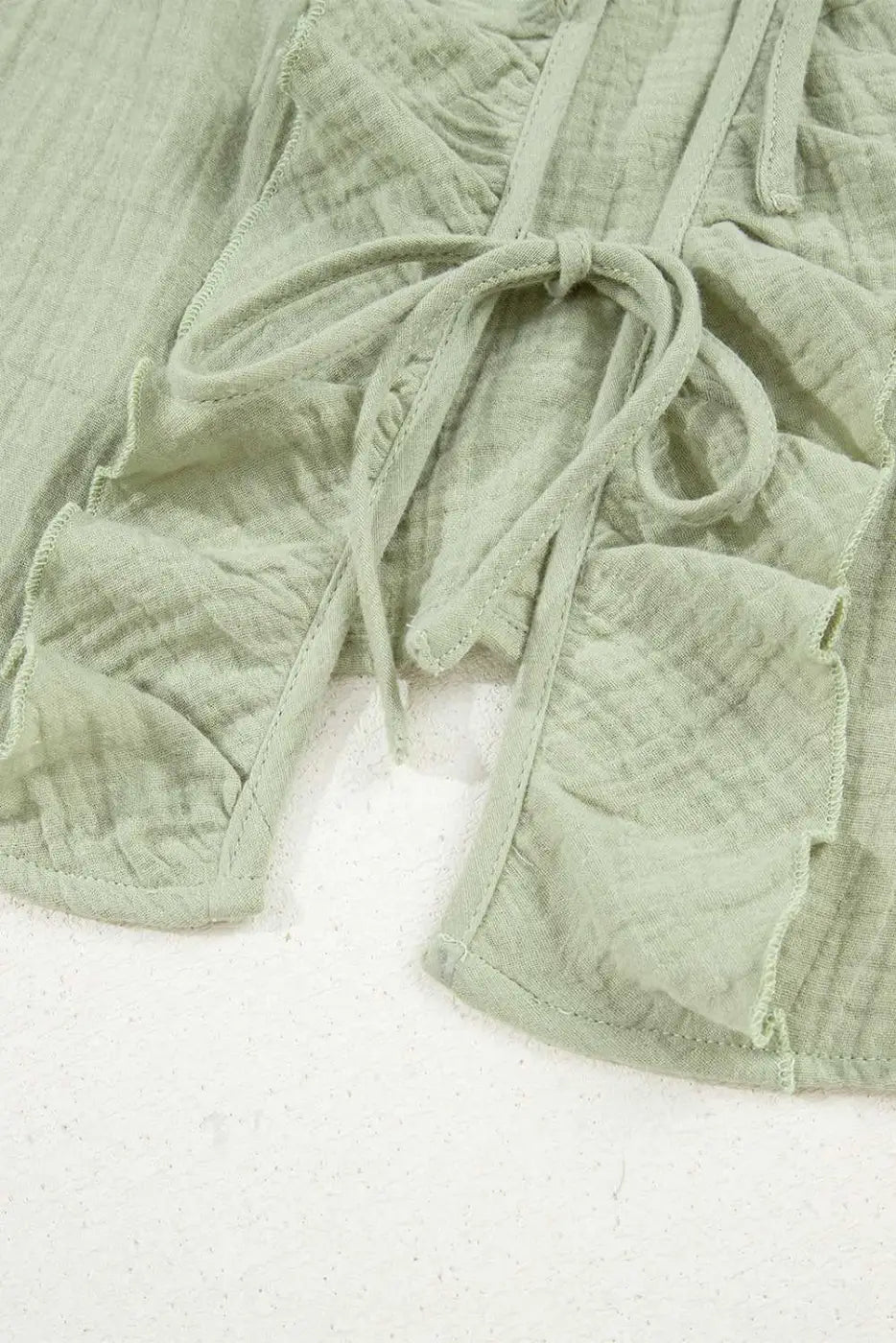 Hem and front tie detail of Meadow Cotton Blouse - Soft & Lightweight | FashionFitz, showcasing ruffle accents and soft cotton fabric.