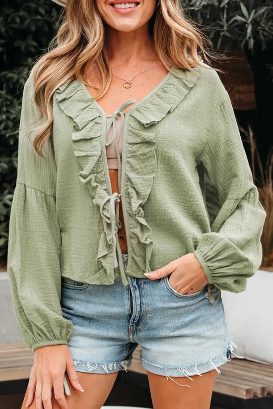 Meadow Cotton Blouse - Soft & Lightweight | FashionFitz in sage green with ruffle trim and front tie, styled with denim shorts for a casual look.