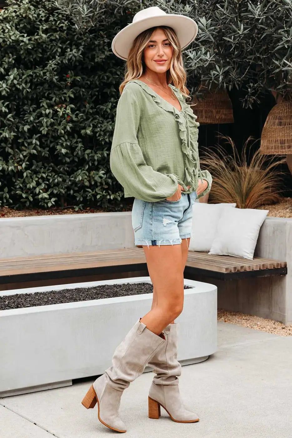 Southern Belle style Meadow Cotton Blouse in green, paired with denim shorts and suede boots, perfect for spring or fall daily wear.
