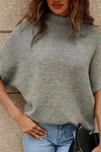 Front close-up of grey short bat sleeve knit sweater paired with denim. Features soft acrylic-cotton blend for daily wear.
