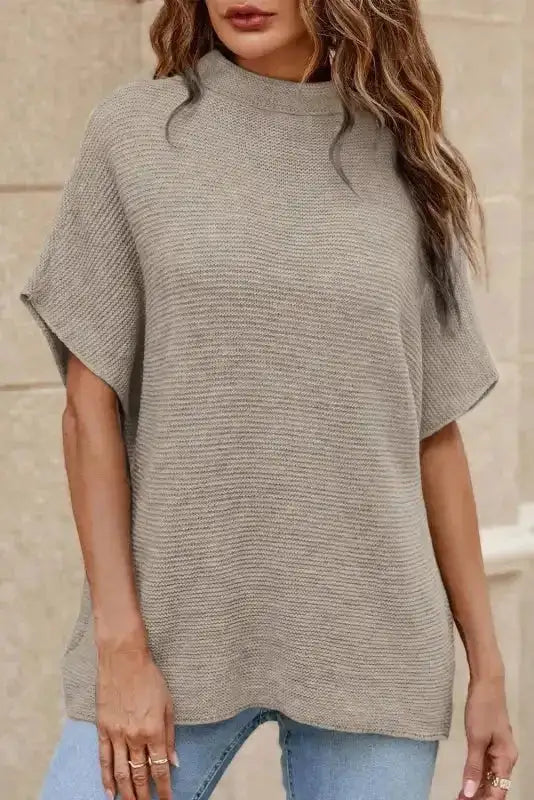 Beige high neck sweater with short bat sleeves styled with jeans. Soft knit fabric perfect for casual fall layering.