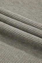 Detailed fabric view of grey high neck sweater showing soft knit weave. Breathable acrylic-cotton blend for fall comfort.