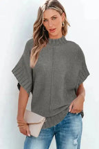 Model wearing gray mock neck batwing knit sweater with short sleeves, styled for a relaxed everyday outfit.