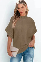 Model wearing khaki mock neck batwing knit sweater, styled for a fashionable and comfortable daily look.