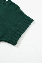 Detailed view of ribbed short sleeve on dark green batwing knit sweater, highlighting quality craftsmanship.