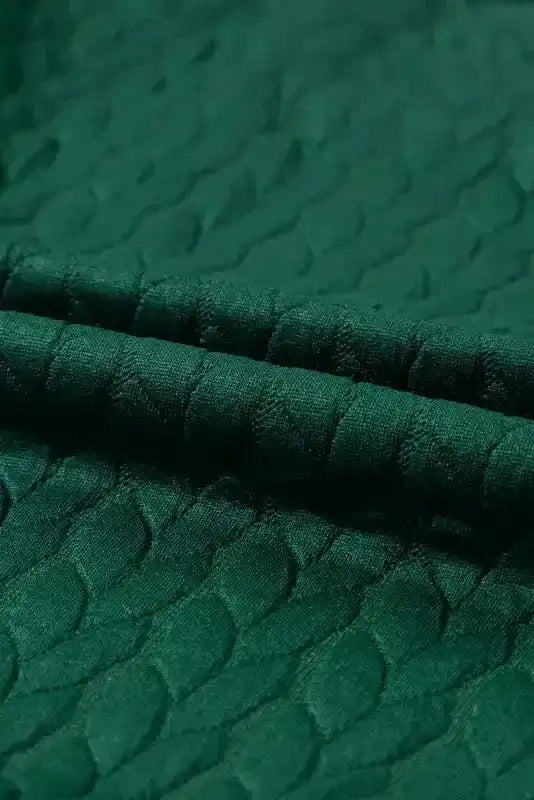 Close-up of green cable knit fabric from Merry And Bright Cable Knit Sweatshirt | FashionFitz showing soft, textured material.