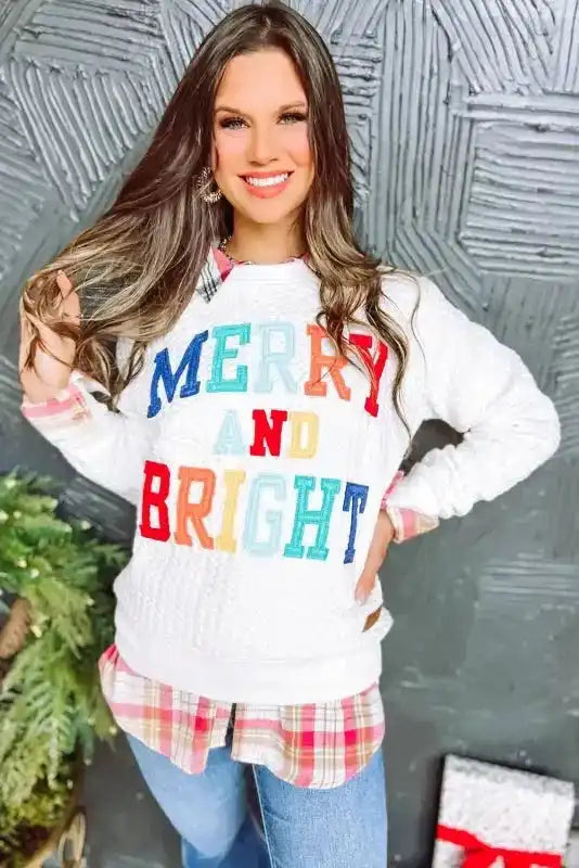 Festive white Merry And Bright Cable Knit Sweatshirt paired with plaid shirt and jeans, great for winter layering.
