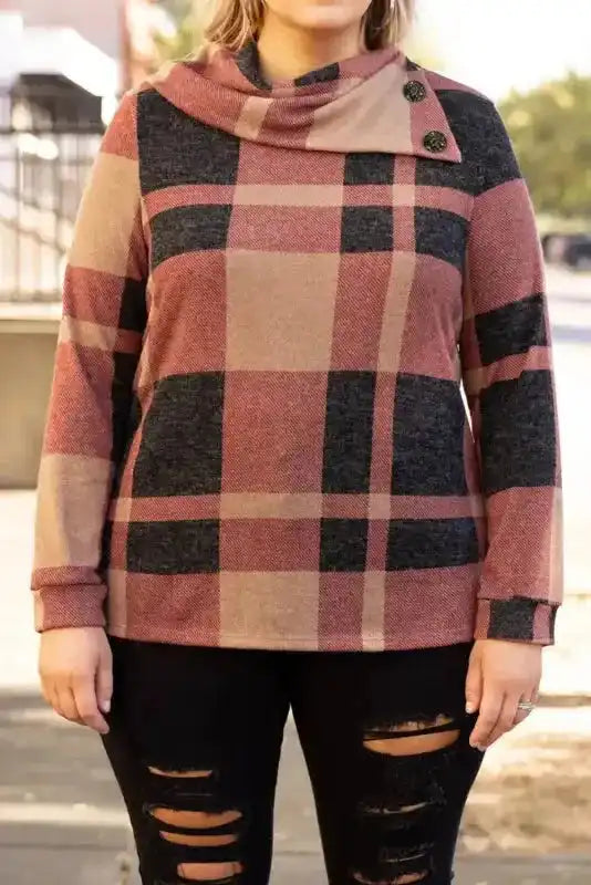 Plus size plaid top in mineral red with asymmetric neck and button detail, styled for casual daily wear with long sleeves and relaxed fit.