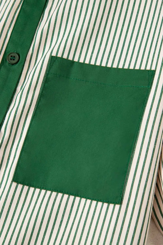 Detail of green pocket on striped mini dress, highlighting the modern monochrome design and casual summer style.