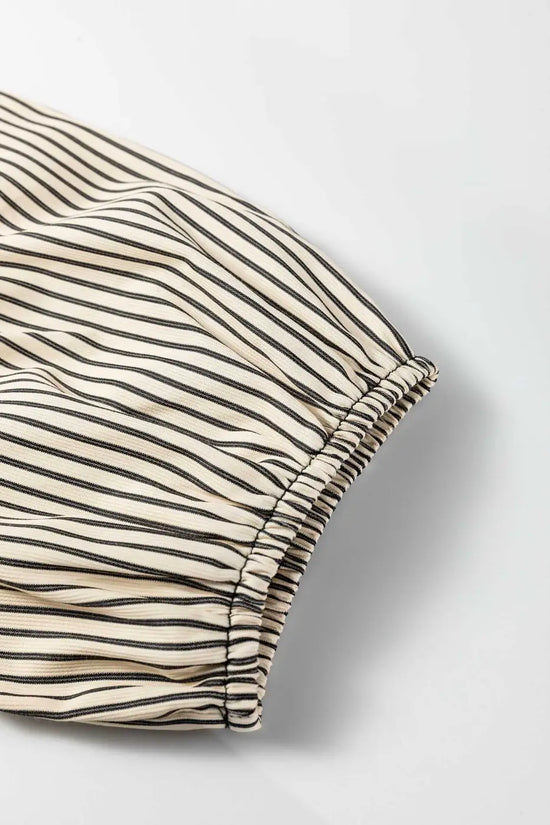 Detail of puff sleeve on Monochrome Striped Puff Sleeve Mini Dress with elastic hem and lightweight striped fabric for summer wear.