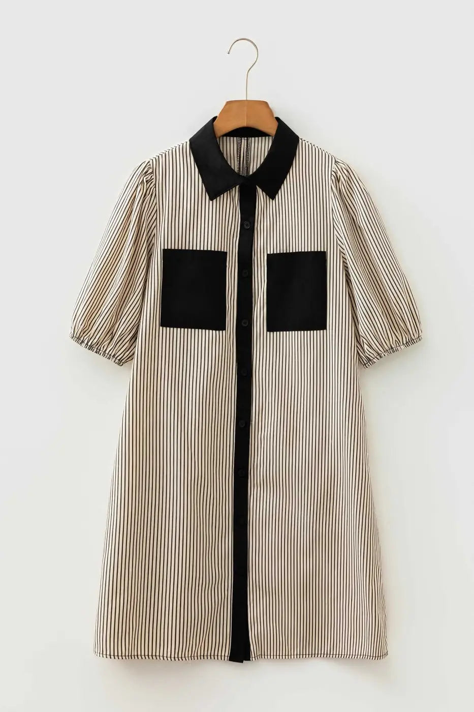 Monochrome striped mini dress with black collar and pockets on hanger, showcasing modern casual design for daily wear.