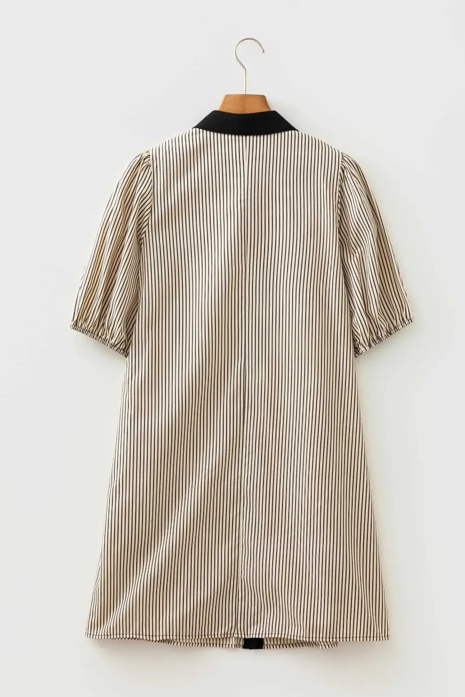Back view of monochrome striped puff sleeve mini dress on hanger, highlighting relaxed fit and lightweight summer fabric.