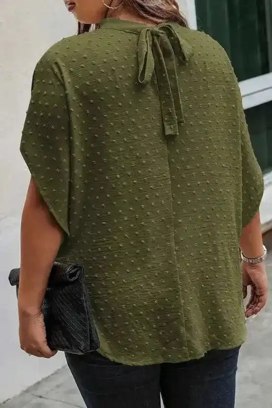 Back view of moss green Swiss dot mock neck plus size blouse featuring a tied nape detail and relaxed fit, ideal for daily wear.