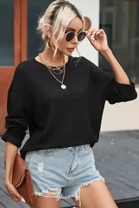 Relaxed fit moss green knit top in plus size, styled with gold accessories and denim shorts for a casual autumn outfit.