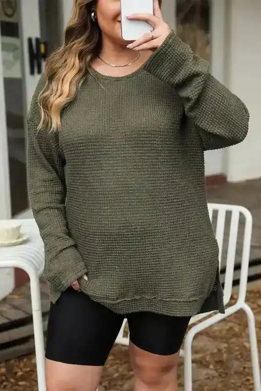 Plus Size Moss Green Knit Top styled with biker shorts, featuring long sleeves and a relaxed fit for everyday comfort.