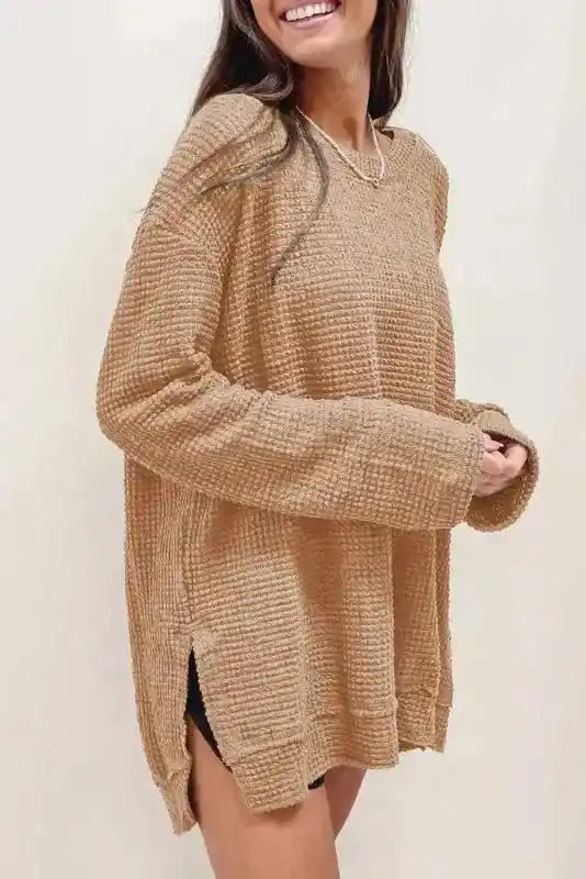 Side view of model in tan Chic Knit Top - Plus Size Moss Green | Long Sleeve Style, showing side slit and long sleeve casual design.