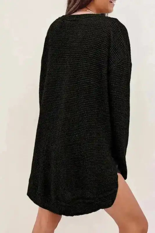 Back view of Plus Size Black Knit Top showing relaxed fit and soft waffle knit texture, ideal for layering in cooler seasons.