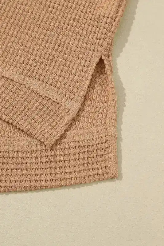 Close-up of hem and side slit on tan Chic Knit Top - Plus Size Moss Green | Long Sleeve Style, showcasing casual design and textured knit.