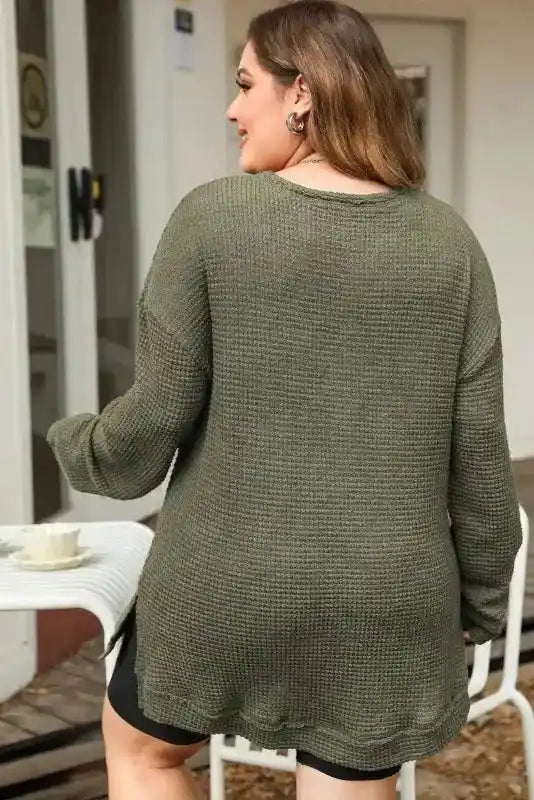 Back view of Plus Size Moss Green Knit Top styled outdoors, highlighting its loose fit and cozy waffle knit fabric.