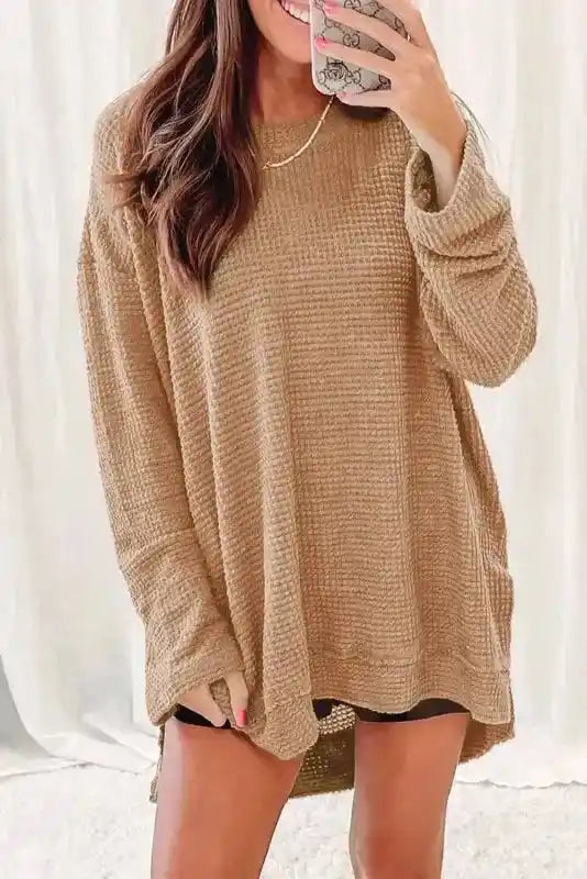 Model wearing tan Chic Knit Top - Plus Size Moss Green | Long Sleeve Style, styled casually with shorts, showcasing relaxed fit and textured knit.
