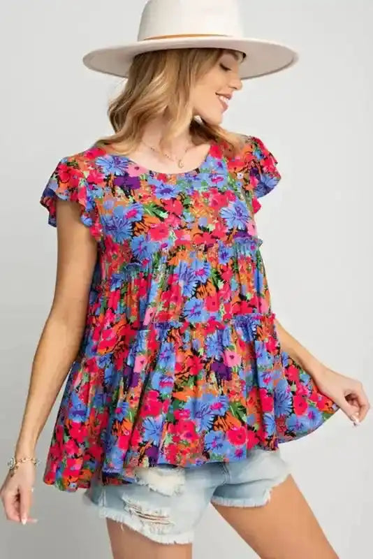 Side view of floral babydoll top for women with ruffled sleeves and tiered design, styled for a casual and feminine summer look.