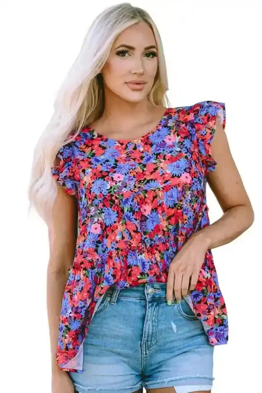 Front view of floral babydoll top for women in pink and blue floral print, styled with denim shorts for effortless summer style.
