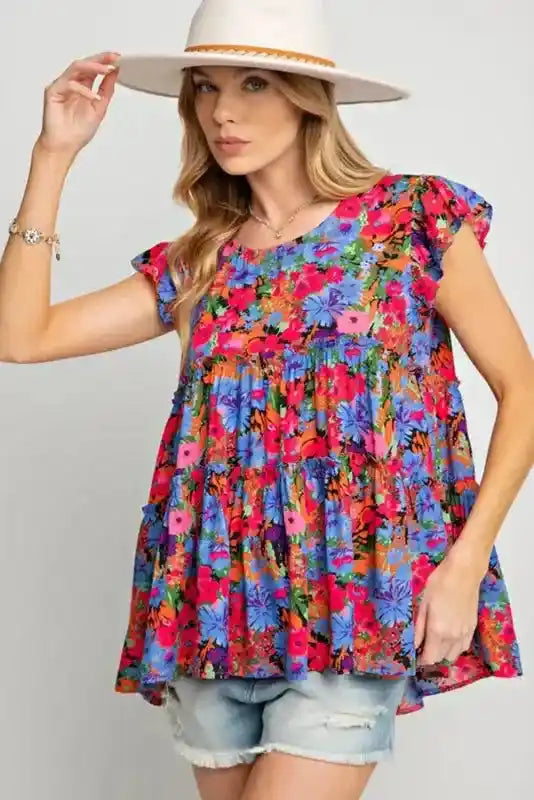 Model wearing floral babydoll top for women with wide-brim hat, showcasing a Southern Belle-inspired summer outfit.