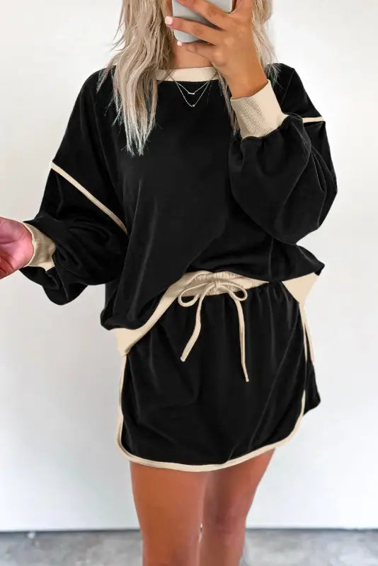 Noir chic pullover and skort set