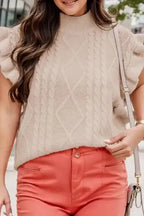 Oatmeal plus cable knit short ruffled sleeve sweater styled with coral pants, featuring a mock neck and textured diamond knit pattern.