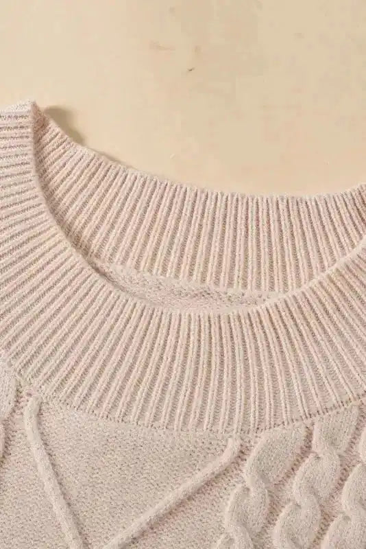 Close-up of ribbed mock neck on oatmeal plus cable knit short ruffled sleeve sweater, emphasizing comfort and structure.