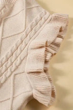 Detailed view of ruffled sleeve on oatmeal plus cable knit sweater, showcasing ribbed texture and feminine flutter design.