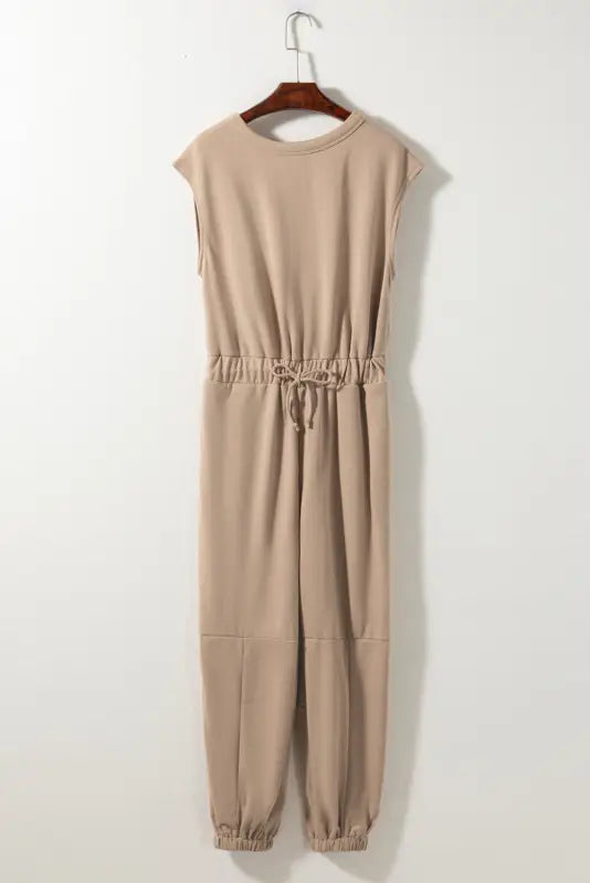 Open back drawstring jogger jumpsuit: beige, sleeveless, elastic cuffs, relaxed fit